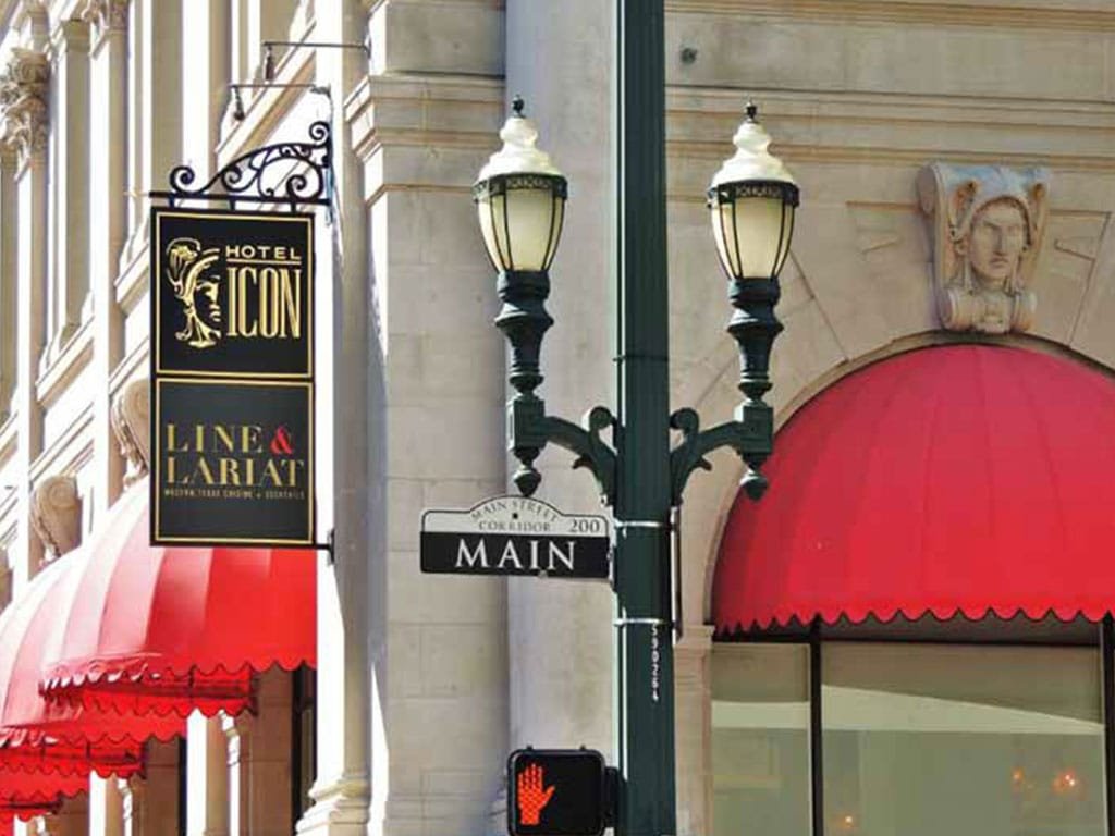 Hotel Icon and Line and Lariat blade sign on a historic street corner